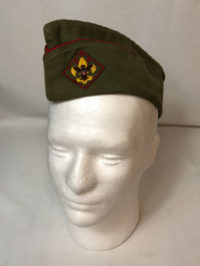 The flat, or "garrison" cap was introduced in 1943 as the second official hat of the BSA, after the campaign hat. The official BSA flat cap is rarely seen despite still being an approved part of Scout uniforms because it has not been manufactured for more than 20 years.