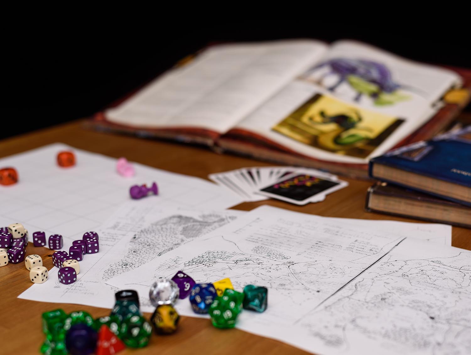 Game map, book and dice on a table