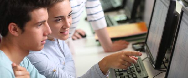 Three students working together at a computer