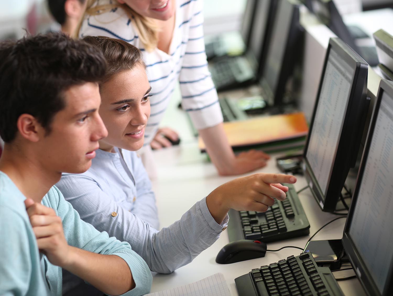 Three students working together at a computer